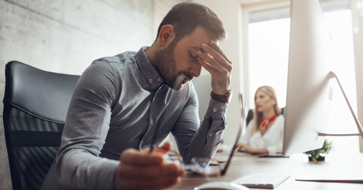 Office employee stressed at his desk